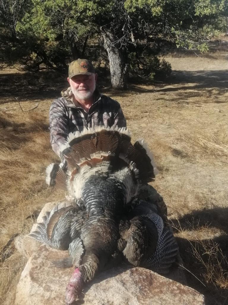 Hunter with a Gould's turkey, Sierra Madre, Chihuahua
