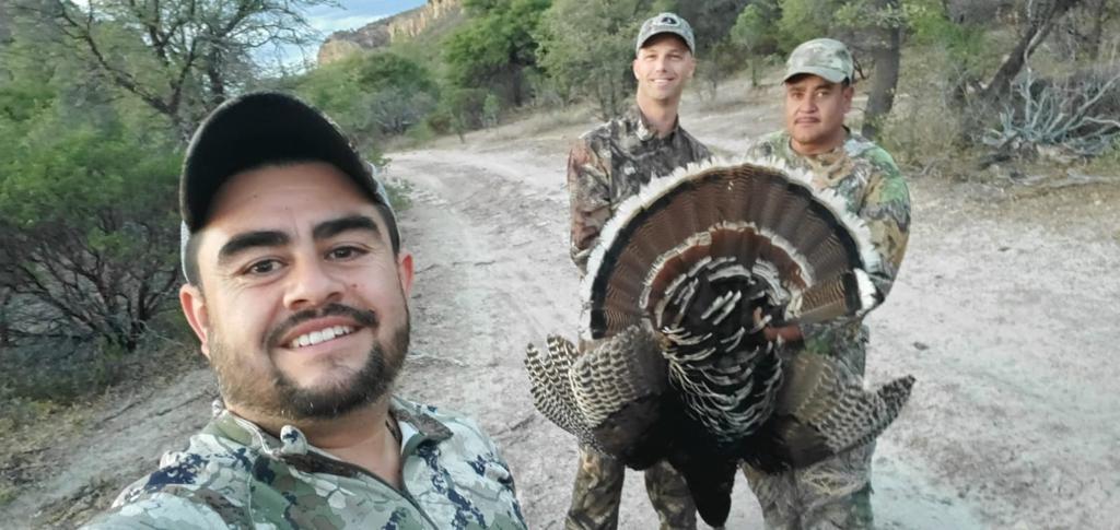 Hunters with a Gould's turkey, road through the concession