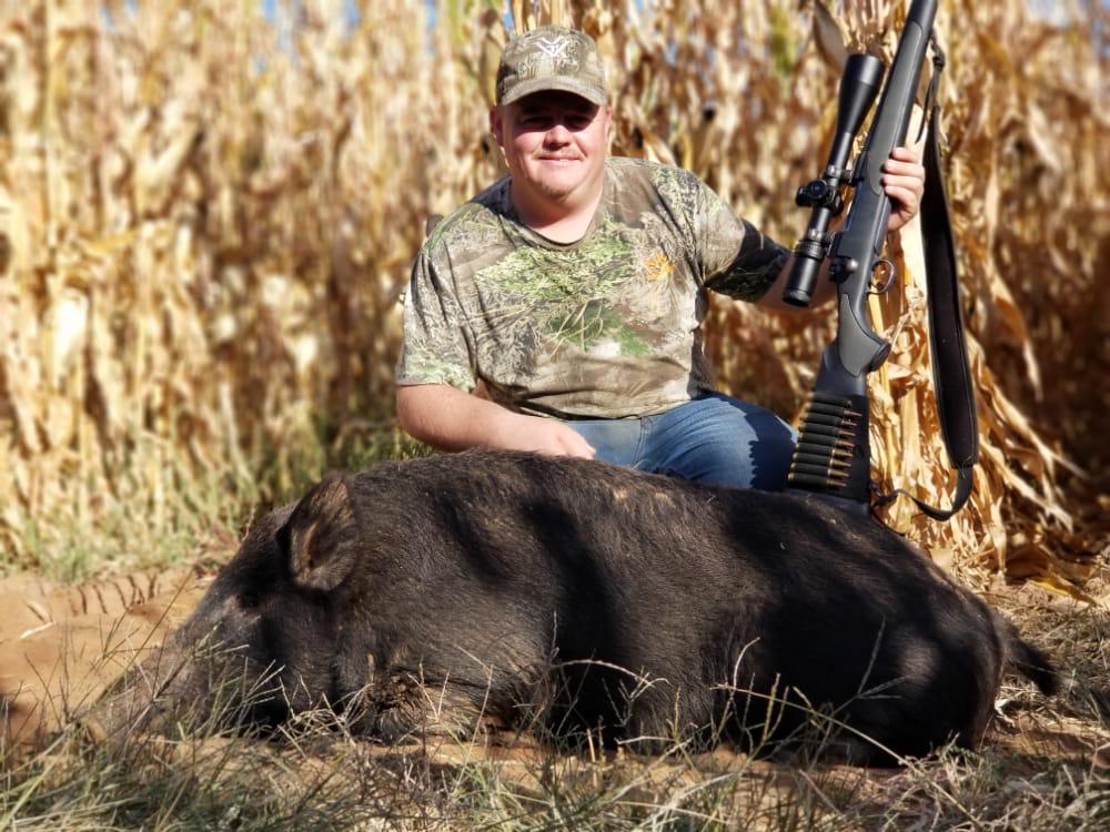 Hunter with harvested hog