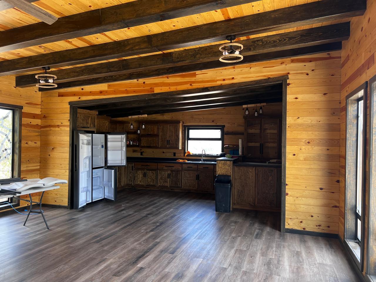 Lodge kitchen interior — full pine cabinets and exposed beams