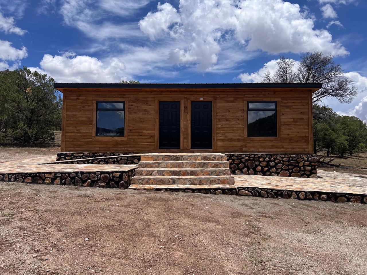 Cabin exterior — front entry with twin doors and stone porch