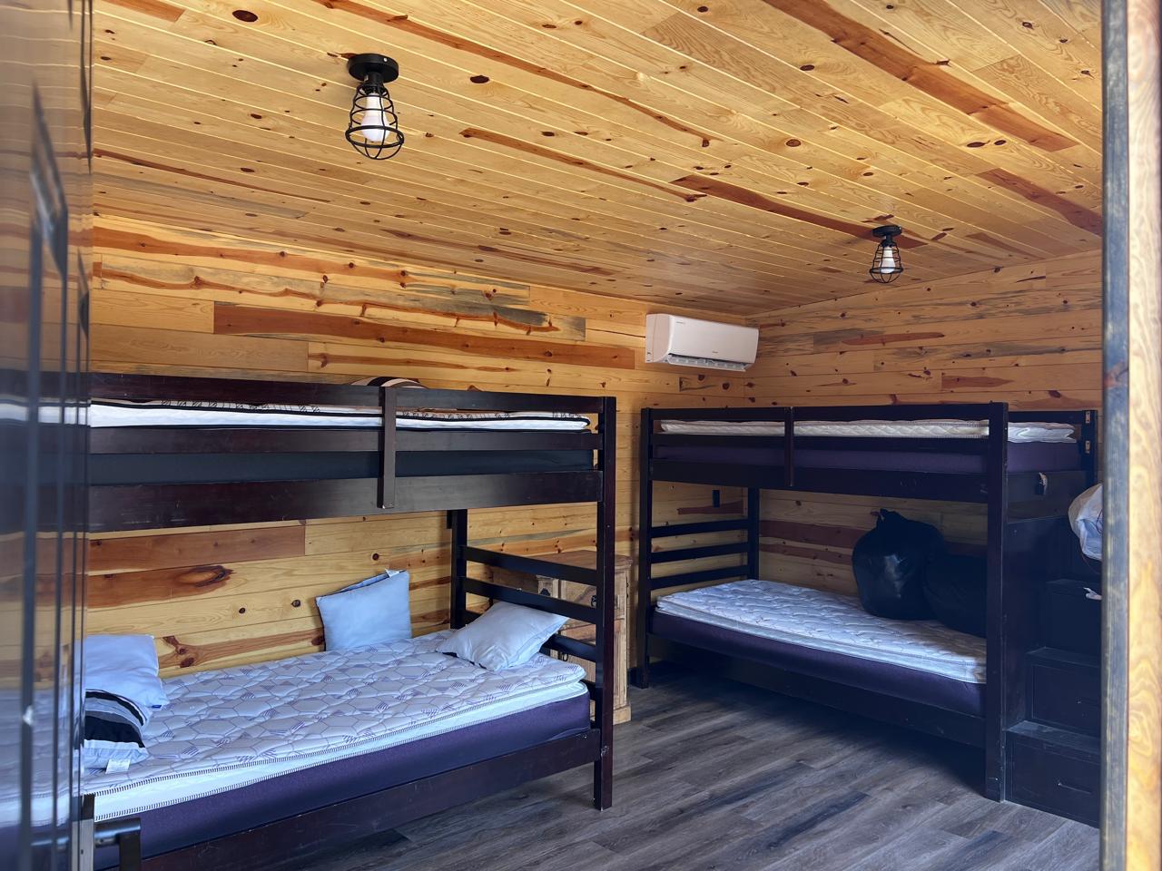 Bunk room — sleeps four, pine walls and ceiling